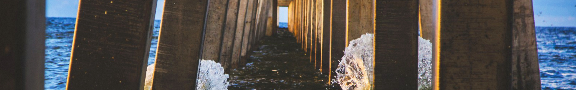 Peer Support banner: Wooden support beams leading towards an ocean