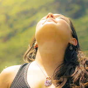 Woman facing up toward sun