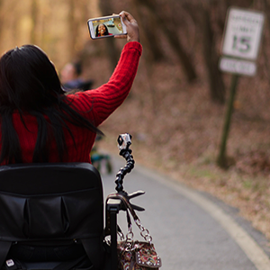 Woman taking a selfie while on the road in her wheelchair