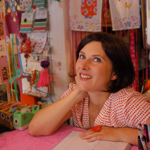 A woman sitting behind a counter