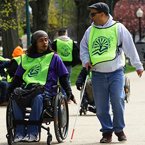 Two people with disabilities talking during a march