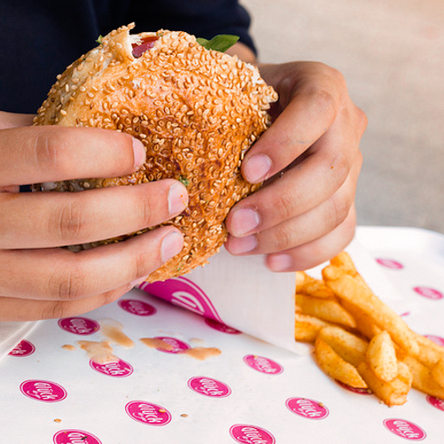 Person holding a hamburger