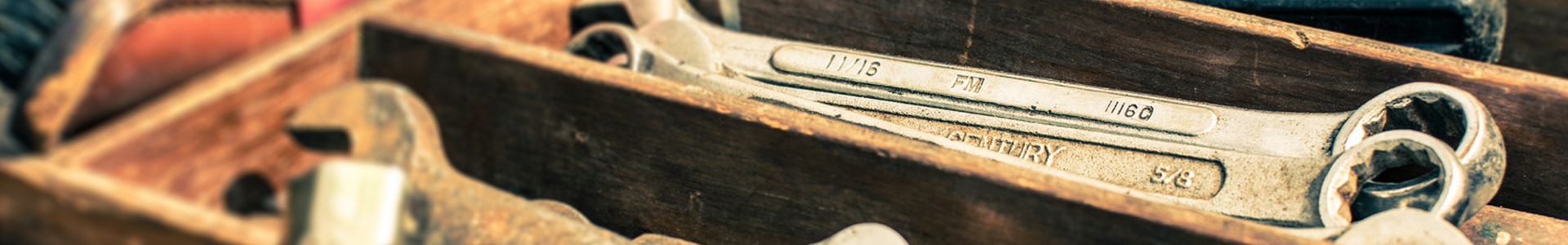 (Session Header Image): Rusty wrenches in a worn wooden toolbox.