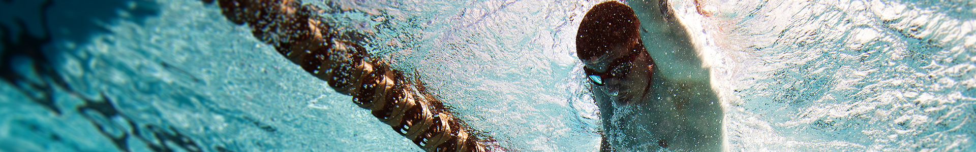 (Session Header Image): A man in goggles swims in his lane, as viewed from beneath the surface of the water. (U.S. Marine Corps photo by Lance Cpl. Chelsea Flowers)