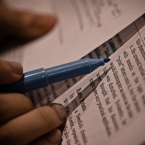 Pen highlighting text on paper