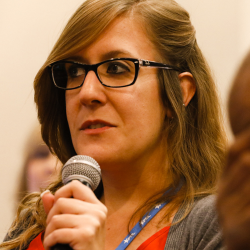 Woman talking into a microphone