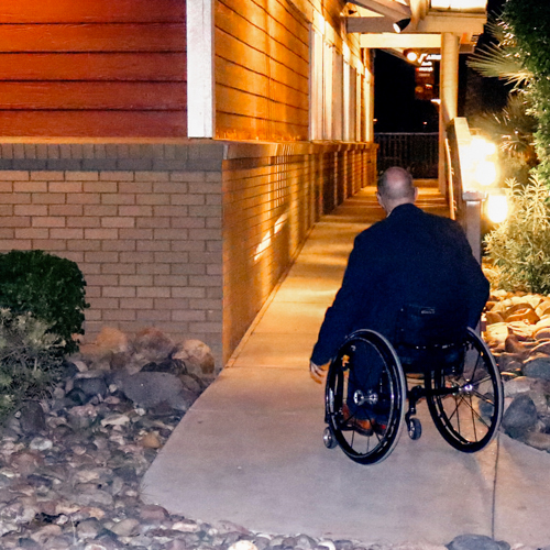 Man in wheelchair using ramp