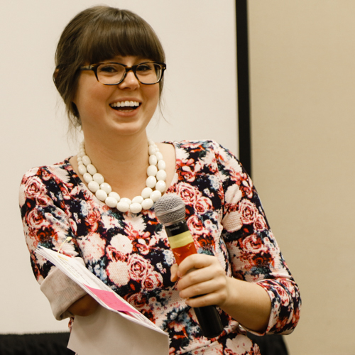 Woman laughing and holding microphone