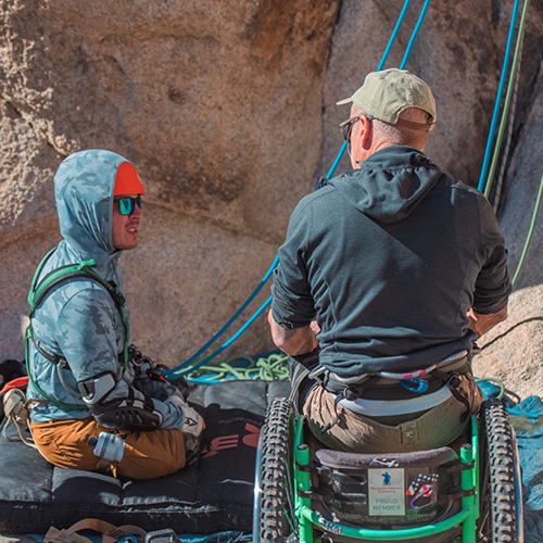 Man with prosthetic legs rock climbing