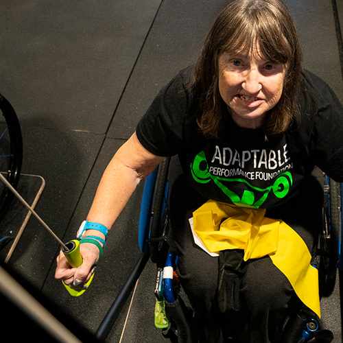 Woman using assistive exercise equipment