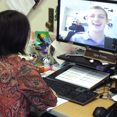 Two people talk through a video conference