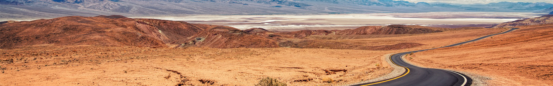 Orientation banner: Road winding through desert landscape