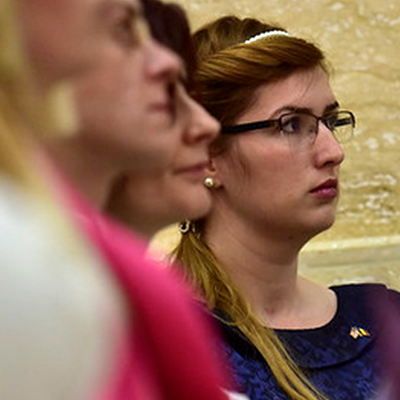 Three women looking at someone out of frame